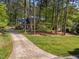 Home with long driveway surrounded by mature trees at 4533 Wood Valley Dr, Raleigh, NC 27613