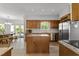 Spacious kitchen featuring wooden cabinets, granite countertops, a center island, and stainless steel appliances at 4533 Wood Valley Dr, Raleigh, NC 27613