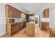Well-lit kitchen featuring wood cabinetry, granite countertops, and a stainless steel refrigerator at 4533 Wood Valley Dr, Raleigh, NC 27613