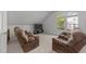 Cozy living room featuring a large window, carpeted floors, and two recliner chairs at 4533 Wood Valley Dr, Raleigh, NC 27613