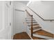 Hallway with wood stairs and white trim at 4533 Wood Valley Dr, Raleigh, NC 27613