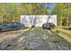 Detached garage with multiple bays, providing ample parking and storage space, surrounded by trees at 5019 Dorsey Rd, Oxford, NC 27565