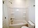 Standard white tub and shower with wall shelves in the bathroom at 58 S Grace Way, Henderson, NC 27537