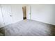 Bedroom with plush carpet and two doors at 58 S Grace Way, Henderson, NC 27537