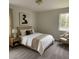 Cozy bedroom with neutral colors, plush carpet, and a large window offering ample natural light at 58 S Grace Way, Henderson, NC 27537