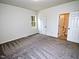 Bedroom with carpet flooring, featuring a door to the bathroom at 58 S Grace Way, Henderson, NC 27537