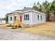 Charming home featuring a red front door and a small covered porch at 58 S Grace Way, Henderson, NC 27537