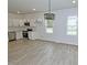 Well-lit kitchen with stainless steel appliances and ample counter space in an open layout at 58 S Grace Way, Henderson, NC 27537