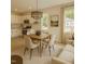 Stylish kitchen and dining area with stainless steel appliances, white cabinets, and hardwood floors at 58 S Grace Way, Henderson, NC 27537