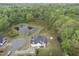 A sprawling home with a back deck overlooks a pond with a view of surrounding trees at 6024 Lunenburg Dr, Raleigh, NC 27603