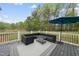 Relax with friends on the back deck with patio furniture and an umbrella at 6024 Lunenburg Dr, Raleigh, NC 27603