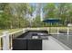 Lounge on the deck, enjoying the large backyard, lush trees, and blue skies at 6024 Lunenburg Dr, Raleigh, NC 27603