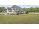 An exterior view of the home showing a large deck and expansive backyard at 6024 Lunenburg Dr, Raleigh, NC 27603