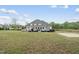 A sprawling back exterior view of the home, deck, and large backyard at 6024 Lunenburg Dr, Raleigh, NC 27603