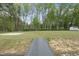A beautiful backyard, complete with a gray composite deck, and lush green trees at 6024 Lunenburg Dr, Raleigh, NC 27603