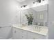 Bright bathroom featuring a double vanity with white cabinets, stylish fixtures, and an elegant mirror at 6024 Lunenburg Dr, Raleigh, NC 27603