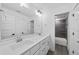 Modern bathroom featuring double sinks, a large mirror, and a tiled shower area with sleek finishes at 6024 Lunenburg Dr, Raleigh, NC 27603