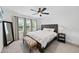 Bright bedroom featuring a ceiling fan, stylish bed frame, and lots of natural light from the windows at 6024 Lunenburg Dr, Raleigh, NC 27603
