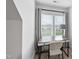 Bright bedroom featuring a modern desk area and large windows with natural light streaming in at 6024 Lunenburg Dr, Raleigh, NC 27603