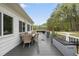 Spacious deck with outdoor furniture, an umbrella, and a picturesque view of the surrounding yard at 6024 Lunenburg Dr, Raleigh, NC 27603