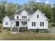 Beautiful modern farmhouse featuring stone accents, manicured landscaping, and a welcoming front porch at 6024 Lunenburg Dr, Raleigh, NC 27603