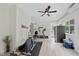 Bright home gym with exercise equipment, white walls, wood floors, and a black ceiling fan at 6024 Lunenburg Dr, Raleigh, NC 27603
