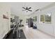 Spacious home gym area featuring exercise equipment, mini fridge, and natural light from the windows at 6024 Lunenburg Dr, Raleigh, NC 27603