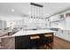 Open concept kitchen featuring white cabinets, granite countertops, and a large center island at 6024 Lunenburg Dr, Raleigh, NC 27603
