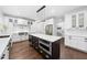 Gourmet kitchen featuring stainless steel appliances, a center island with seating, and custom cabinetry at 6024 Lunenburg Dr, Raleigh, NC 27603