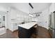 Kitchen featuring a large island, stainless steel appliances, and sleek white cabinetry at 6024 Lunenburg Dr, Raleigh, NC 27603
