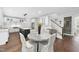 Eat-in kitchen boasts an island, stone countertop, and a staircase at 6024 Lunenburg Dr, Raleigh, NC 27603