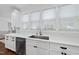 Modern kitchen featuring stainless steel appliances, sleek white cabinetry, and a stylish backsplash at 6024 Lunenburg Dr, Raleigh, NC 27603