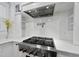 Modern kitchen featuring stainless steel appliances, gas range, and sleek white cabinetry at 6024 Lunenburg Dr, Raleigh, NC 27603