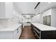 Kitchen featuring a large island, stainless steel appliances, and sleek white cabinetry at 6024 Lunenburg Dr, Raleigh, NC 27603