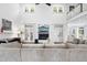 Bright living room with a fireplace, tall windows, and a large comfortable sectional sofa at 6024 Lunenburg Dr, Raleigh, NC 27603
