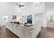Bright living room with a fireplace, tall windows, and a large comfortable sectional sofa at 6024 Lunenburg Dr, Raleigh, NC 27603