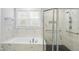 Modern main bathroom showcasing a standalone tub and a glass-enclosed shower at 6024 Lunenburg Dr, Raleigh, NC 27603