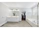Luxurious main bathroom with a double vanity, soaking tub, and walk-in closet at 6024 Lunenburg Dr, Raleigh, NC 27603