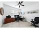A well-lit home office with a ceiling fan, desk, dual monitors and nautical themed decor at 6024 Lunenburg Dr, Raleigh, NC 27603