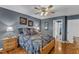 Bedroom featuring hardwood floors, gray walls, a ceiling fan, and a walk-in closet at 604 Young Forest Dr, Wake Forest, NC 27587