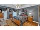 Bedroom boasts a ceiling fan, gray walls, wooden furniture, and natural light at 604 Young Forest Dr, Wake Forest, NC 27587