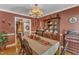 Elegant dining room with a large table set for a gathering and a wooden china cabinet at 604 Young Forest Dr, Wake Forest, NC 27587