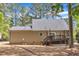 Rear exterior view of home and deck with tree-lined yard and mature trees at 604 Young Forest Dr, Wake Forest, NC 27587