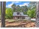 View of the home nestled among lush greenery and mature trees, offering privacy at 604 Young Forest Dr, Wake Forest, NC 27587
