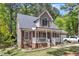 Two-story home featuring a charming front porch and a well-manicured front yard at 604 Young Forest Dr, Wake Forest, NC 27587
