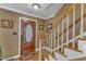 Foyer featuring a wooden front door, staircase with wood banister, and hardwood flooring at 604 Young Forest Dr, Wake Forest, NC 27587