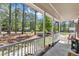 Covered front porch offers a peaceful spot with views of the landscaped front yard and mature trees at 604 Young Forest Dr, Wake Forest, NC 27587