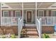 Charming front porch with detailed railing and brickwork, leading to an inviting front door at 604 Young Forest Dr, Wake Forest, NC 27587