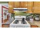 Close up shot of stovetop, cabinets and counter space in a functional kitchen at 604 Young Forest Dr, Wake Forest, NC 27587