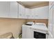 Laundry room featuring cabinetry, washer, and dryer hookups, with stylish decor at 604 Young Forest Dr, Wake Forest, NC 27587